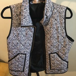 Black and white vest with gold accent zipper